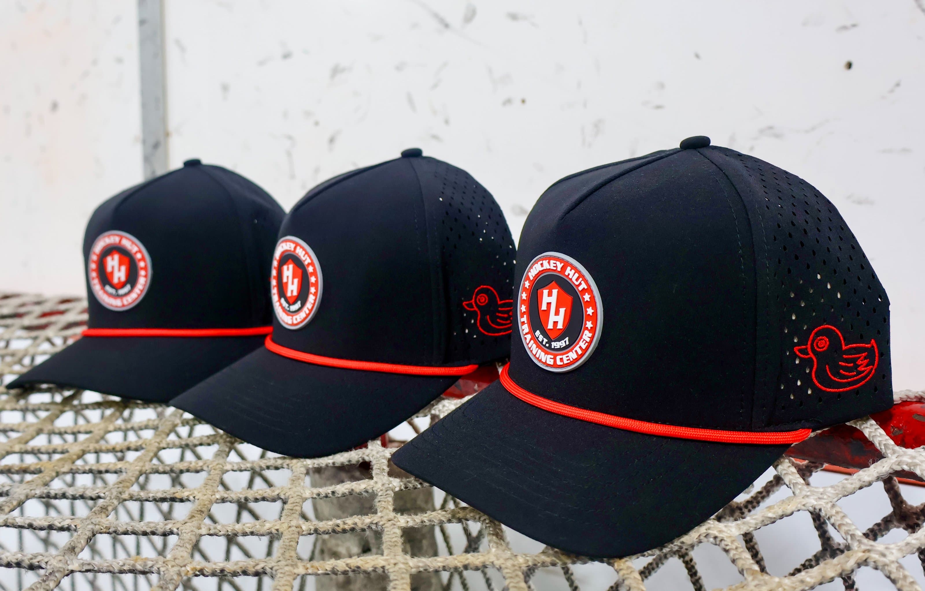 Three custom Happy Duck caps with woven rope trim and custom logo patches