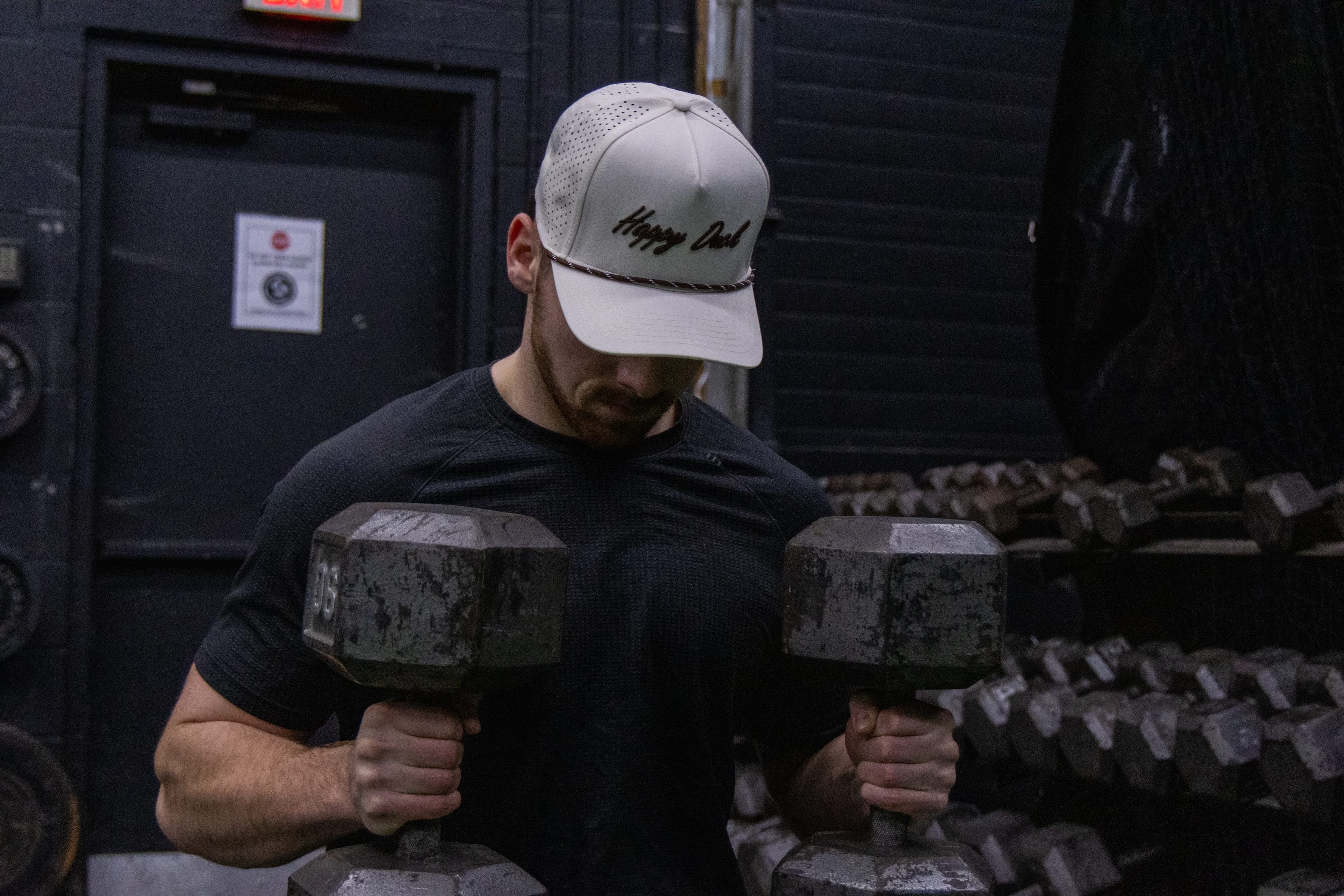 Happy Duck cap in the Mocha colorway next to gym weights